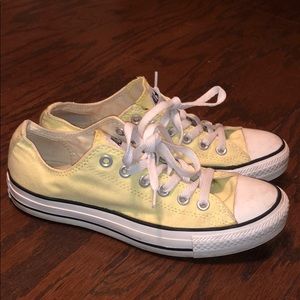 Pale yellow converse shoes